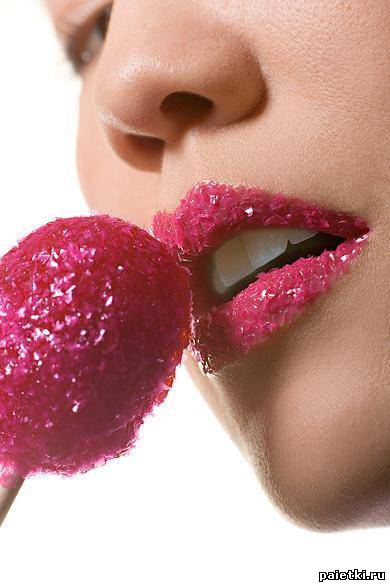 Сахарные кристалики на губах у девушки с конфетой