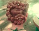 Прическа с плетение и цветком из волос