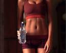 Загорелая спортивная девушка с бутылкой воды PUMA