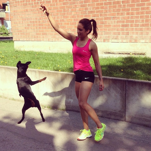 Спортивная девушка с чёрной собакой