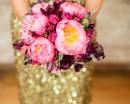 Букет розовых пионов в руках женщины в блестящем
