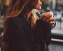 Девушка в свитере с кофе в руках