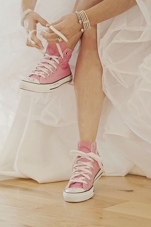 Невеста завязывает шнурки на розовых кедах